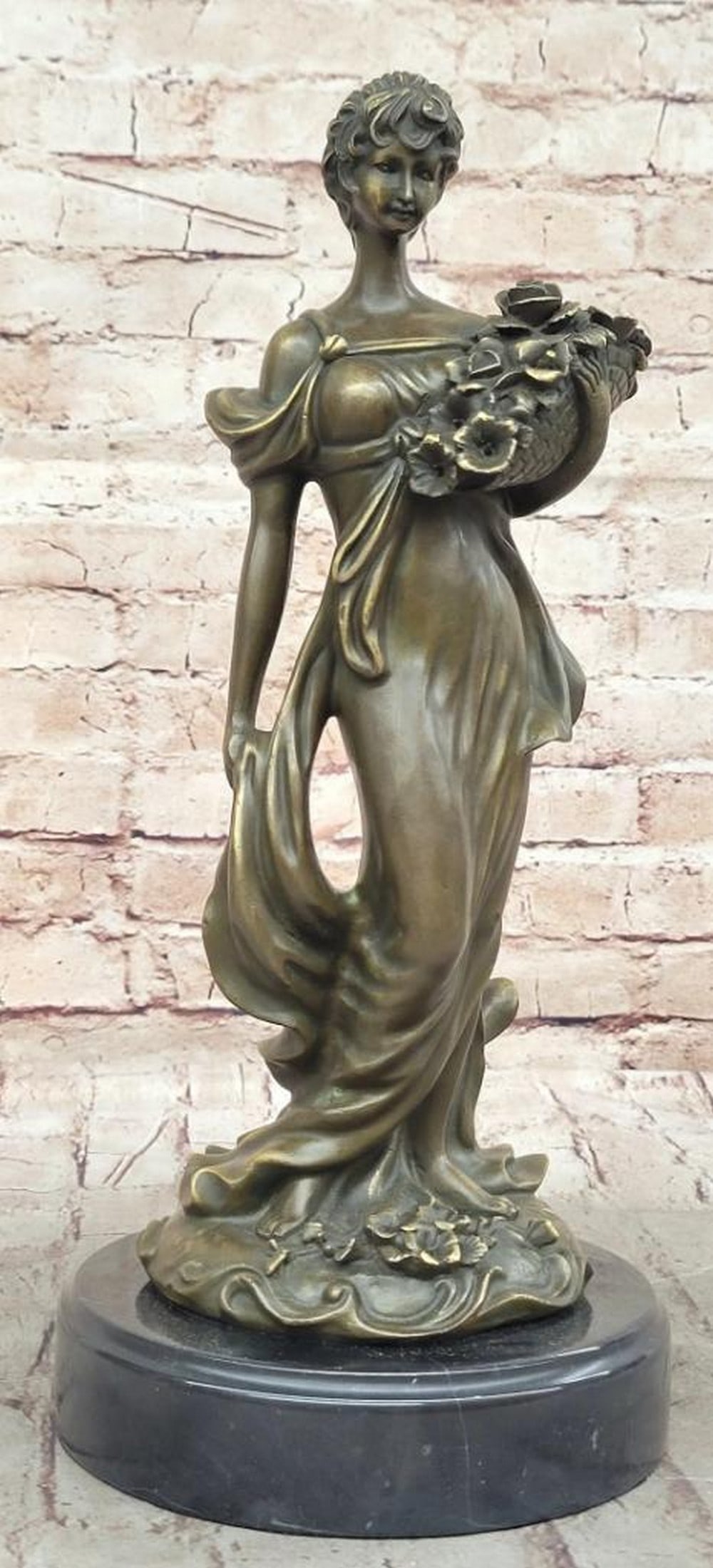 Bronze Sculpture of Woman with Flower Basket by Milo - 14.5" x 7": Bronze Sculpture of Woman with Flower Basket by Milo - 14.5" x 7" This captivating bronze sculpture by Milo portrays a serene woman holding a flower basket, symbolizing grace and femininity. T