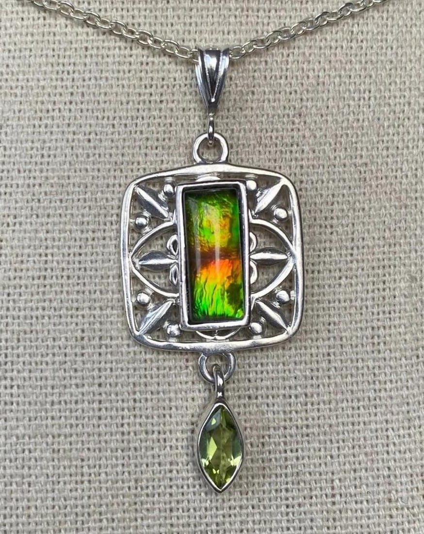 Ammolite Pendant with Multi-Color Gem and Pearl Accent: Ammolite Pendant with Multi-Color Gem and Pearl Accent This pendant features a 12mm x 5mm quartz-capped triplet gem in soft, multi-color pastel tones. The component, bail, and bezel are made of