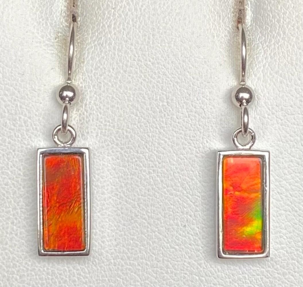 Low Dome Capped Orange Quartz Triplet Earrings: Low Dome Capped Orange Quartz Triplet Earrings These earrings feature 12mm x 5mm low-dome quartz-capped triplets, set in sterling silver with an anti-tarnish rhodium finish. Suspended from