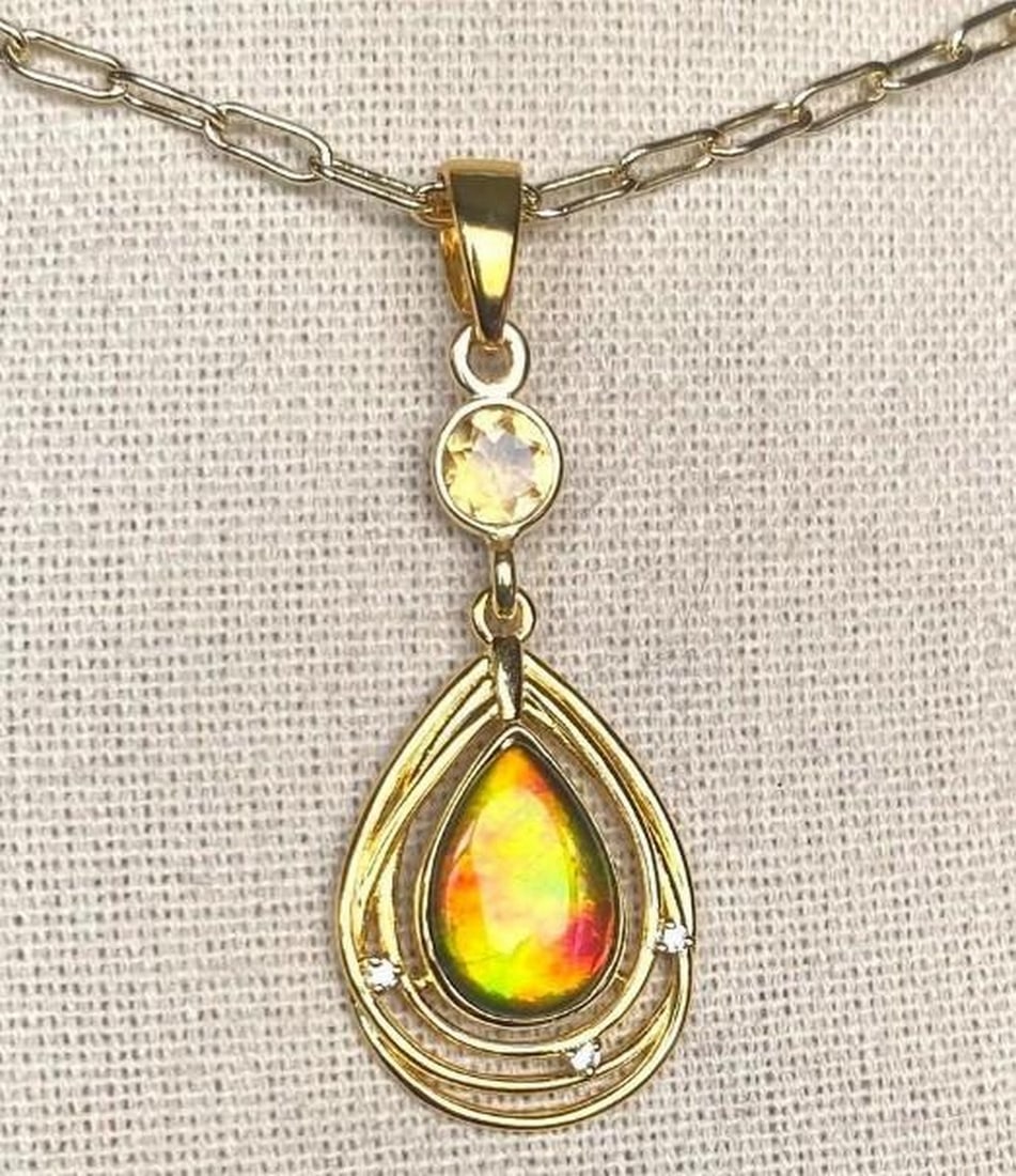 Solara Ammolite Pendant: Solara Ammolite Pendant This is a lovely Ammolite Solara pendant set in a sterling silver gold vermeil bezel and bail with CZ accents. This is a smaller version of the larger Solara, and just