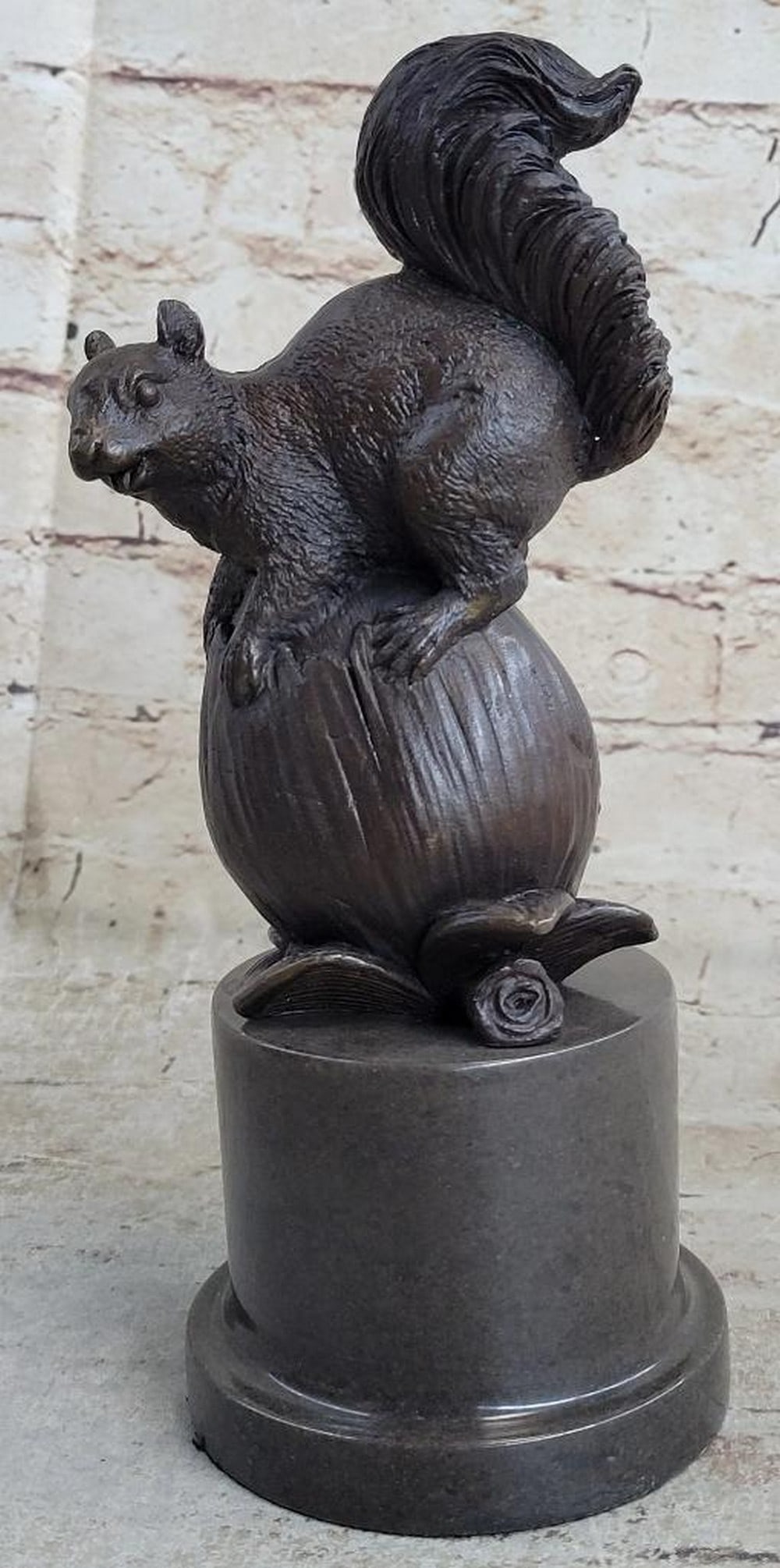 Squirrel Protecting Acorn Inspired Bronze Statue - 9" x 4": Squirrel Protecting Acorn Inspired Bronze Statue - 9" x 4" ] This bronze statue depicts a squirrel standing upright on its hind legs, clutching an acorn close to its chest in a protective sta