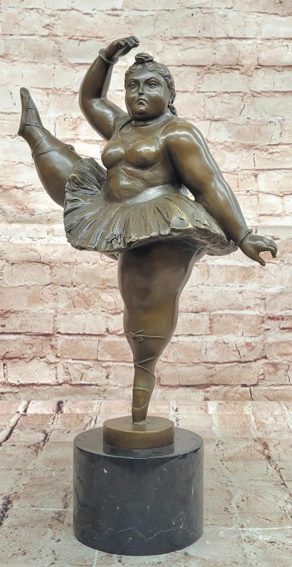 Poised Ballerina" Bronze Sculpture by Fernando Botero – 18" x 11: "Poised Ballerina" Bronze Sculpture by Fernando Botero – 18" x 11" This bronze sculpture by Fernando Botero depicts a ballerina in a graceful pose, with one leg lifted, celebrating