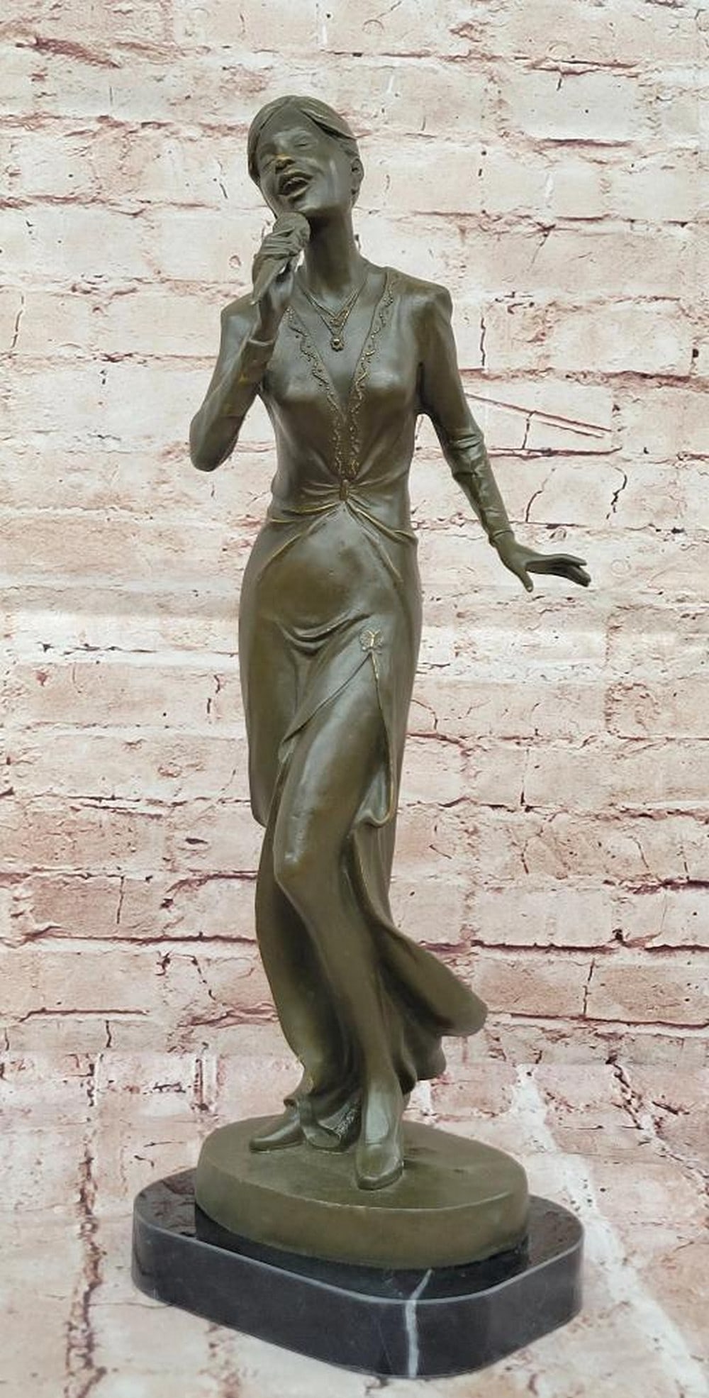 Bronze Jazz Singer Statue – 19.5" x 7": Bronze Jazz Singer Statue – 19.5" x 7" Celebrate the golden age of jazz with this captivating bronze sculpture of an African American jazz singer, captured mid-performance with vintage micro