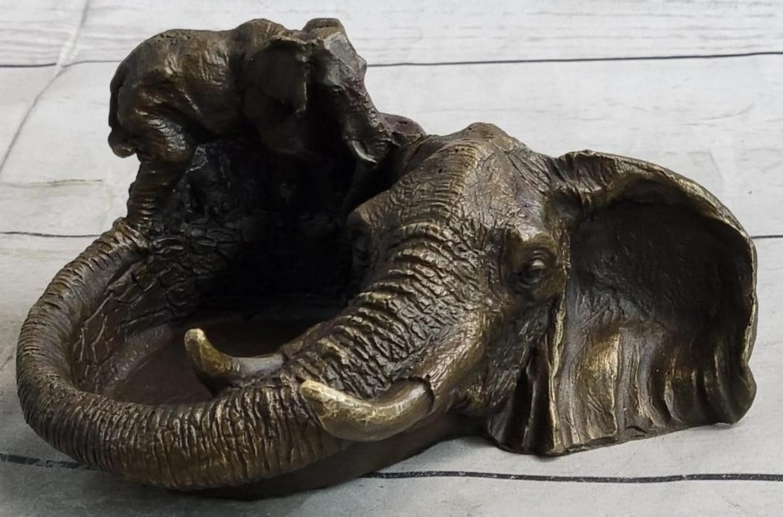 Circle of Wisdom: Elephant Bronze Ashtray Dish: Circle of Wisdom: Elephant Bronze Ashtray Dish Blending artistry with function, this bronze metal ashtray features an imaginative design shaped by two intricately crafted elephants. The dish itself i