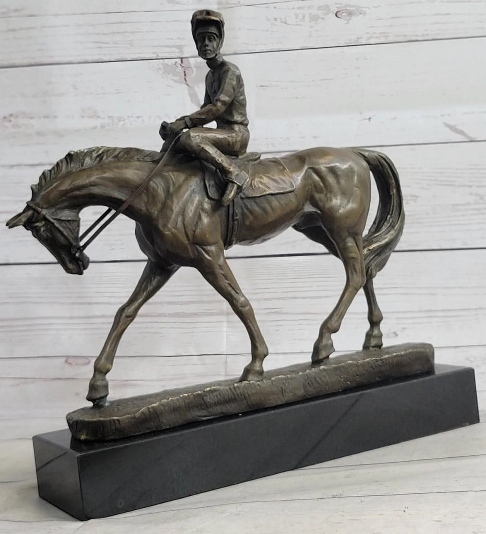 The Polo Champion Bronze Sculpture: The Polo Champion Bronze Sculpture This dynamic bronze sculpture bearing the signature of artist Aldo Vitaleh captures the exhilarating motion of a polo jockey in full stride. The horse, muscles taut