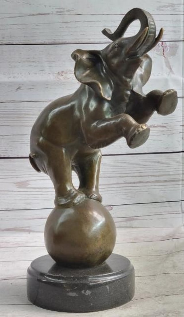 Balancing Act: Circus Elephant Bronze Sculpture: Balancing Act: Circus Elephant Bronze Sculpture A whimsical yet masterfully crafted reproduction bronze sculpture, this piece features a circus elephant gracefully balancing on a ball, a homage to bo