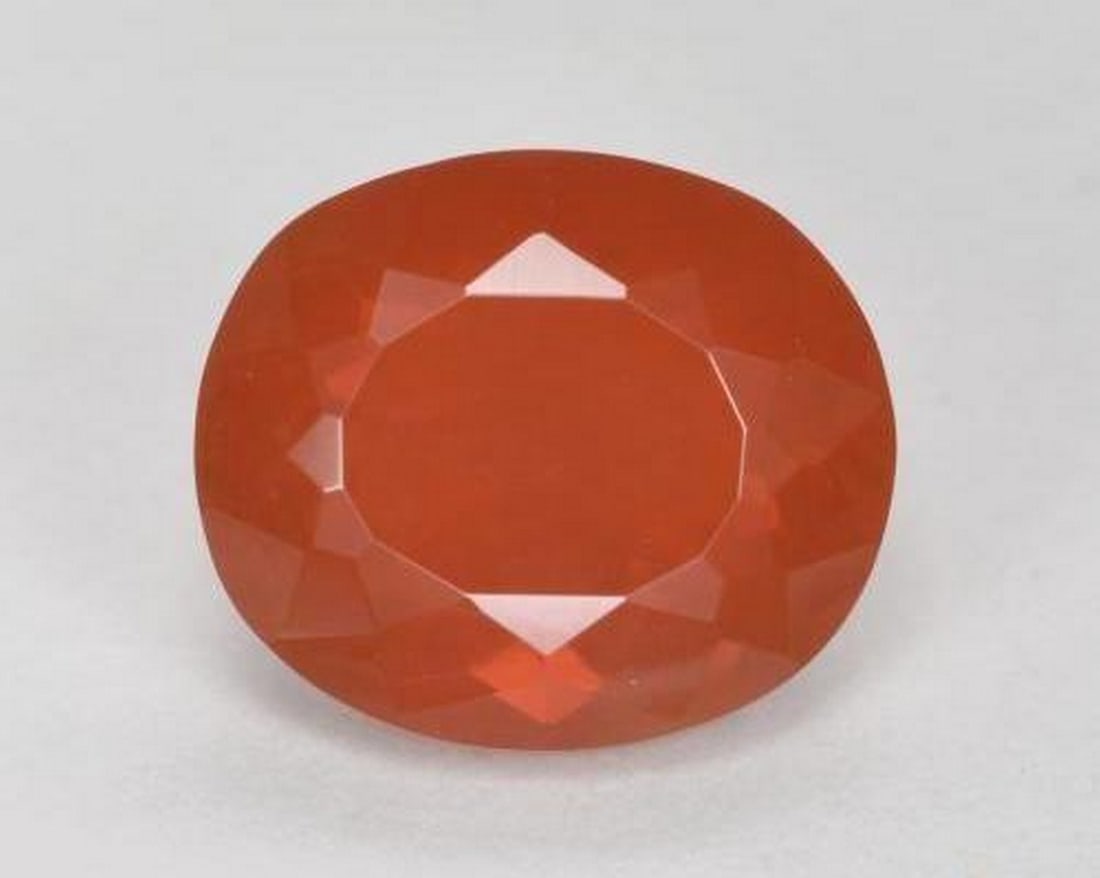 1.50 ct Natural Orange Red Fire Opal, Oval Cut, Transparent, Mexico: 1.50 ct Natural Orange Red Fire Opal, Oval Cut, Transparent, Mexico Natural fire opal gemstone weighing 1.50 ct, cut in an oval facet shape with an orange-red color. The gem measures 8.56 x 7.34 x 5.3