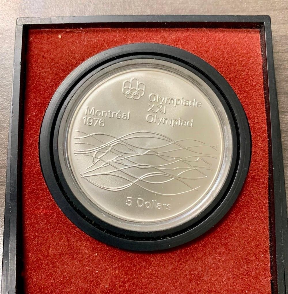 5 Dollars - Elizabeth II Swimming: Commemorative issue 1976 Olympics, Montreal Obverse Bust of Elizabeth II to right. Lettering: ELIZABETH II CANADA 1974 Engraver: Arnold Machin Reverse Waves, Olympics logo Lettering: