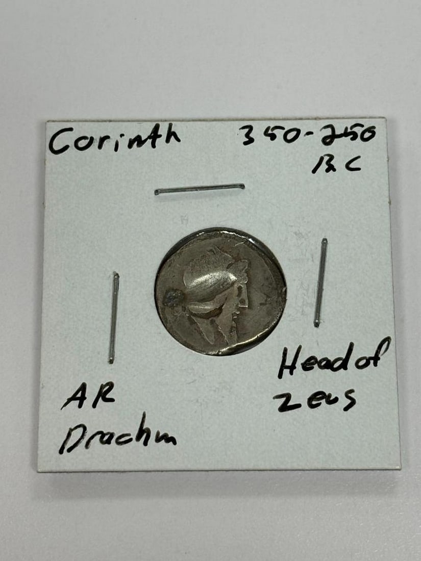 Corinth 350-250BC AR Drachm Head of Zeus: Corinth 350-250BC AR Drachm Head of Zeus Discover the allure of ancient Greek coinage with this Corinthian AR Drachm, dated between 350-250 BC. The coin proudly displays the Head of Zeus, symbolizing