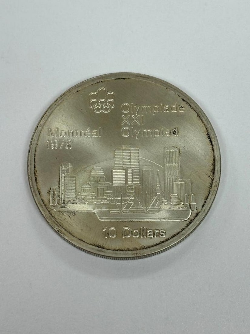1976 Montreal Olympiade XXI 10$ Coin: 1976 Montreal Olympiade XXI 10$ Coin Obverse Bust on the right of Queen Elizabeth II, aged 37, wearing a tiara. Writing: Latin