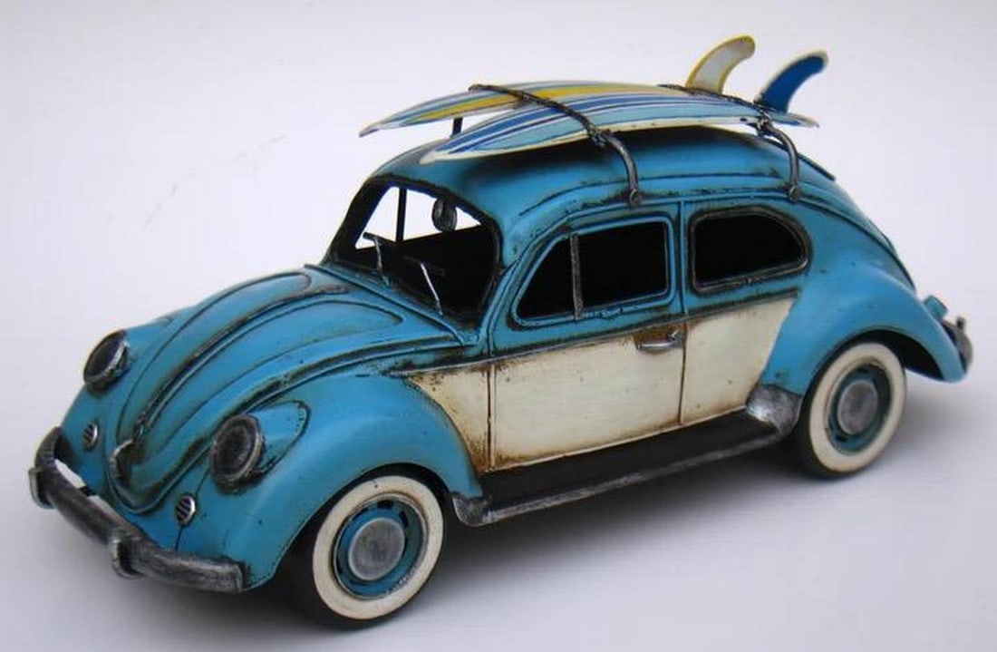 Vintage Classic Die Cast Figurine: 1934 VW Beetle in Light Blue with Surfboards: Vintage Classic Die Cast Figurine: 1934 VW Beetle in Light Blue with Surfboards Introducing a captivating vintage classic art figurine featuring a 1934 VW Beetle elegantly showcased in a charming ligh
