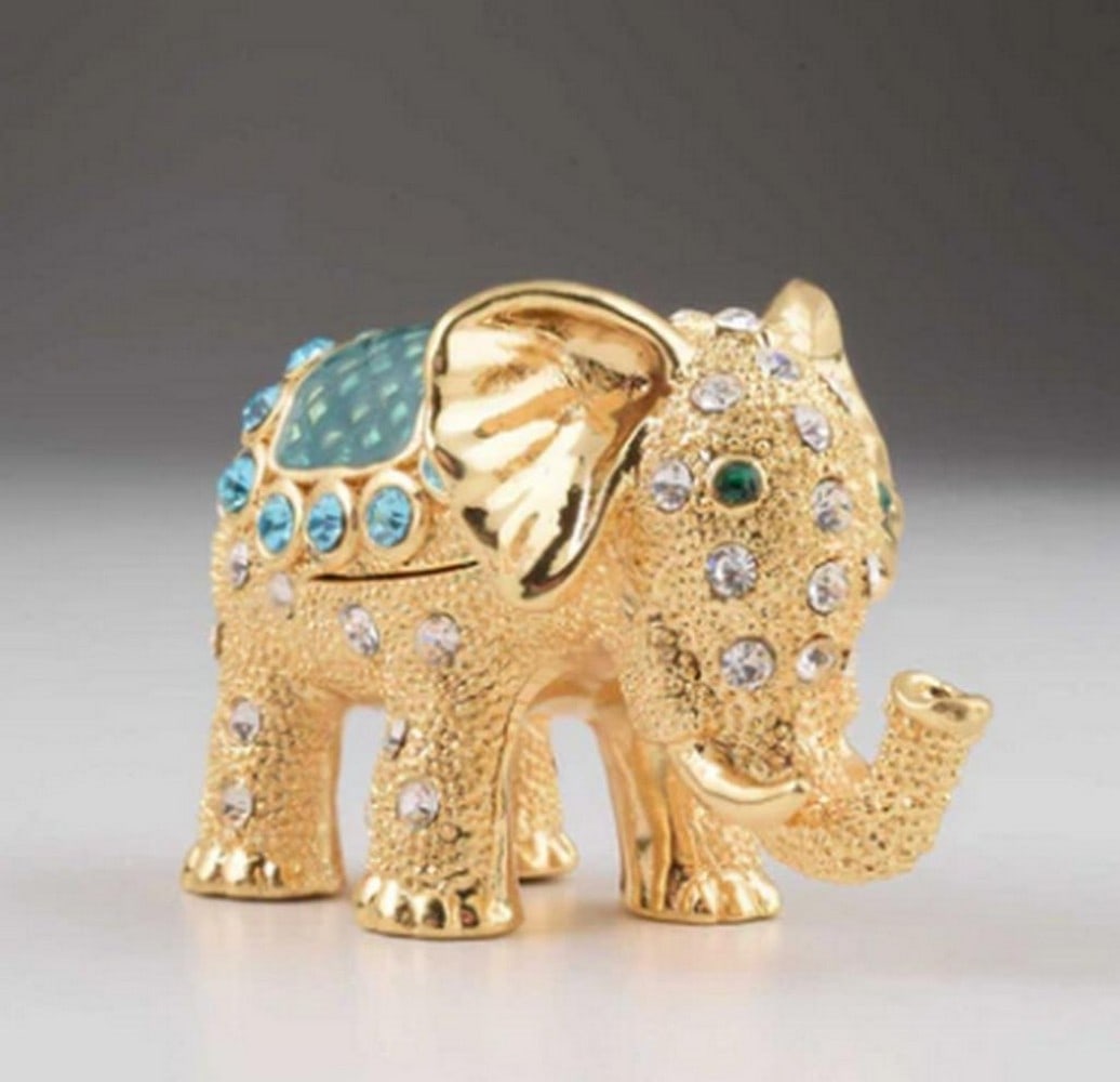 Golden Elephant Figurine Trinket Box: Golden Elephant Figurine Trinket Box This elegant enamel-painted trinket box is beautifully decorated with handpicked Austrian crystals. Plated with either 24K gold or 925 silver, each piece is a work