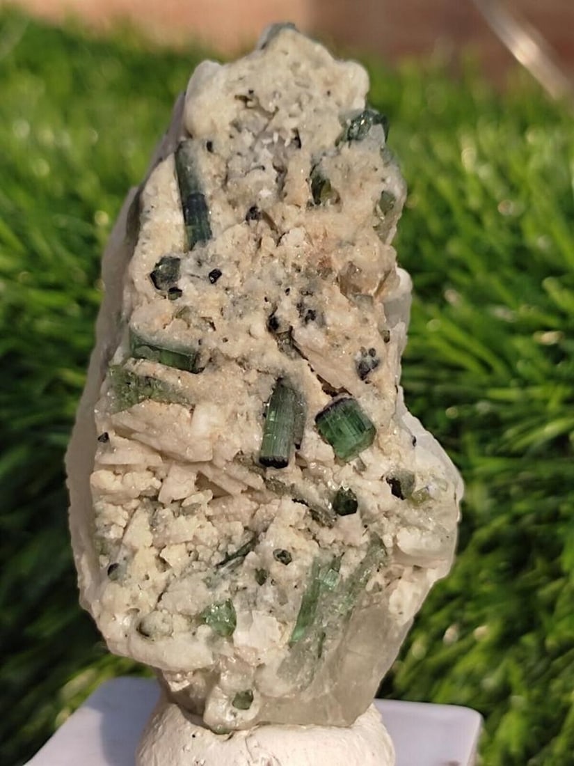 Green Tourmaline Crystals on Cleavelandite Var Albite Mineral Specimen: Green Tourmaline Crystals on Cleavelandite Var Albite Mineral Specimen Weight:76g Length:2mm Width:1.8mm Height:2.5mm View Photos For Further Details