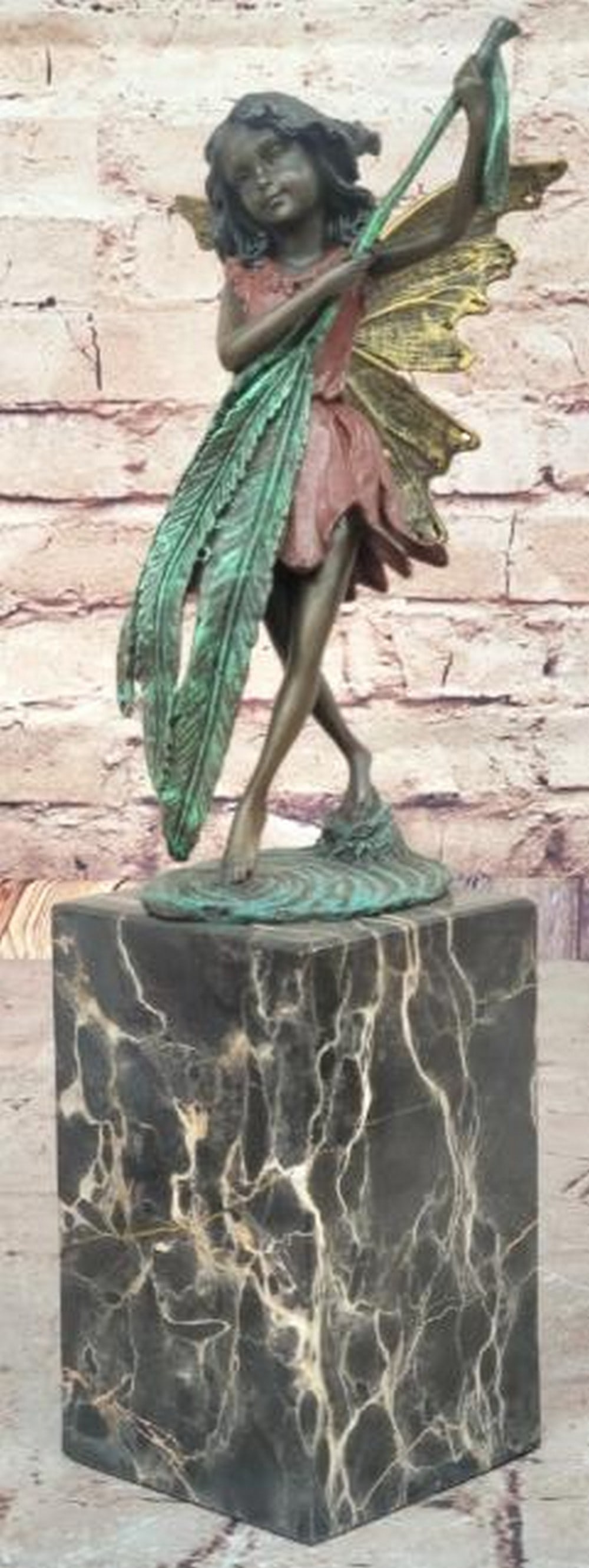 Baby Angel Bronze Sculpture: Baby Angel Bronze Sculpture Daydreamers will fall in love with this daydreaming fairy. She sits on a rock and gazes out into the mystical land around her. She dangles her legs over the si