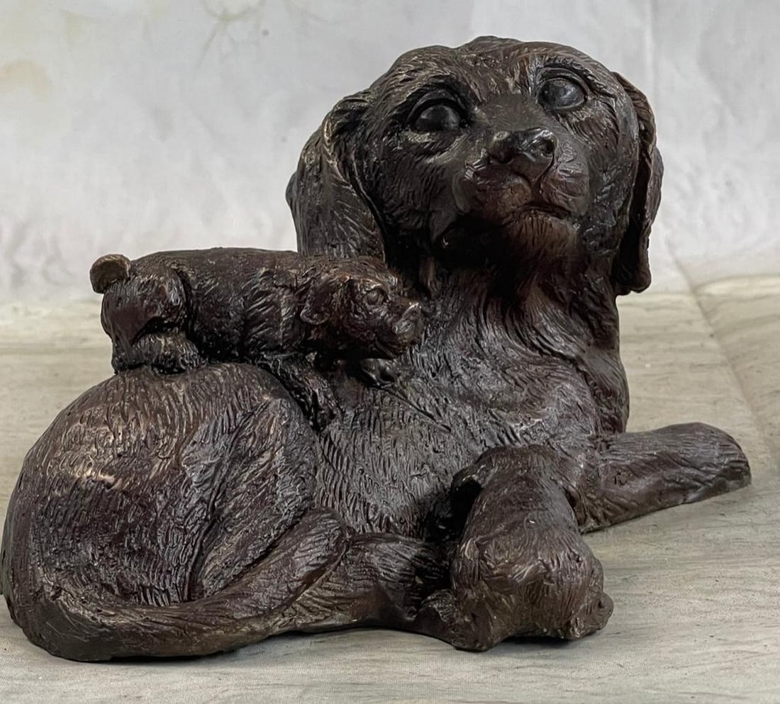 Labrador Retriever and Puppy Bronze Sculpture: Labrador Retriever and Puppy Bronze Sculpture A mother's love is a universal concept between mankind and wildlife. In this sculpture a puppy cuddles up against his mother to drink mil
