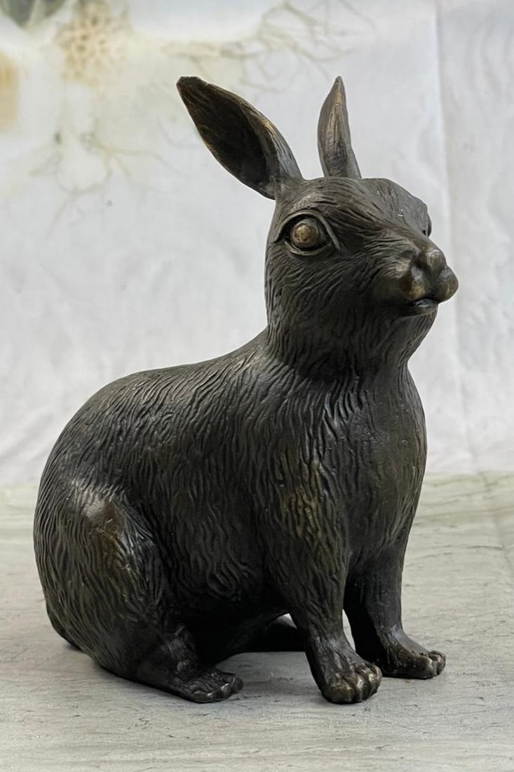 Sitting Bunny Bronze Statue: Sitting Bunny Bronze Statue This cute bunny looks up with the sweetest look and taking a brake from a long day. This little rabbit is the perfect touch of decor for a sweet and loving home. His ears