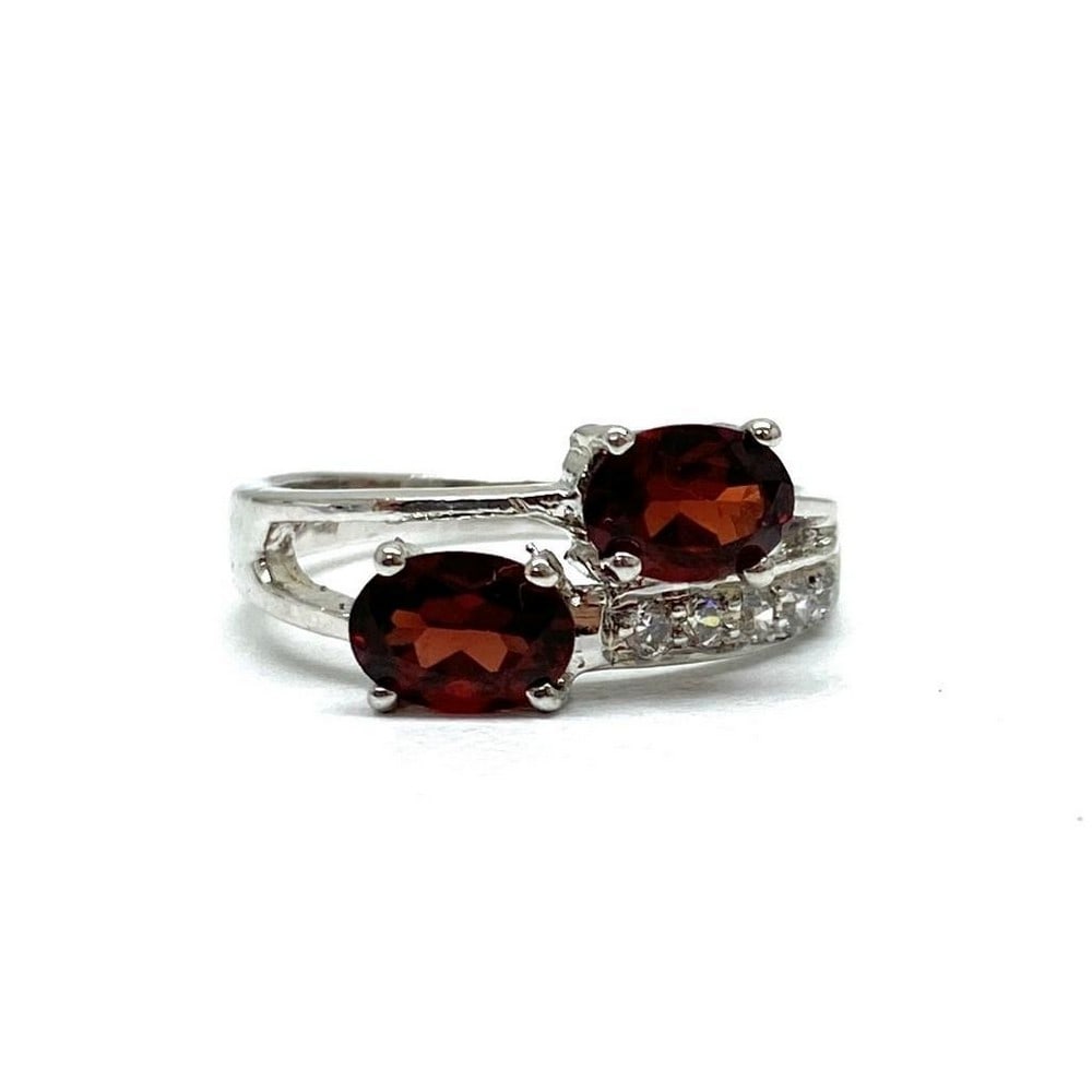 925 Sterling Silver Ring with Double Garnet Stones Surrounded by Austrian Crystals: 925 Sterling Silver Ring with Double Garnet Stones Surrounded by Austrian Crystals. Garnets symbolize love and friendship. They represent the heart, inner fire, and are considered to be a life force.