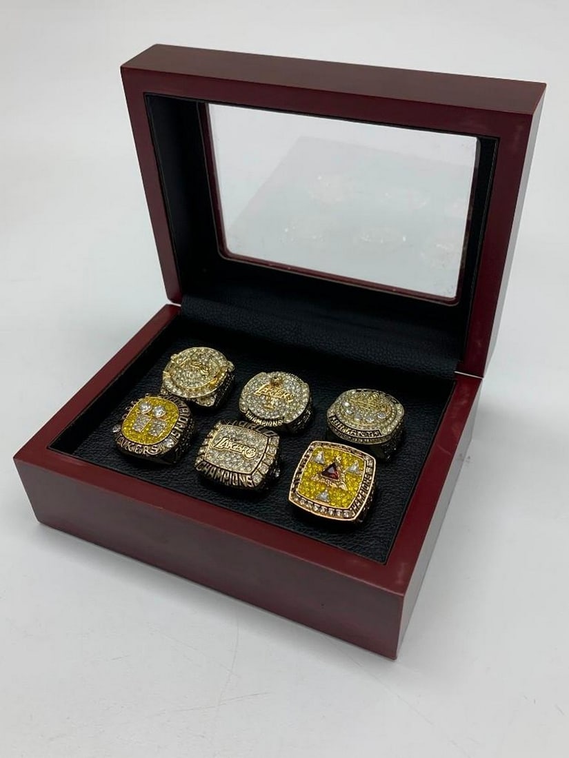 "The Champion" Kobe Bryant Championship Ring Collection: Stunning Collection Of Rings Summarizing Kobe Bryant's Incredible Career. Each Ring Beautifully Crafted with Gold Gilt And Decorated With Semi-Precious Stones Perfectly Created To Replicate Kobe B