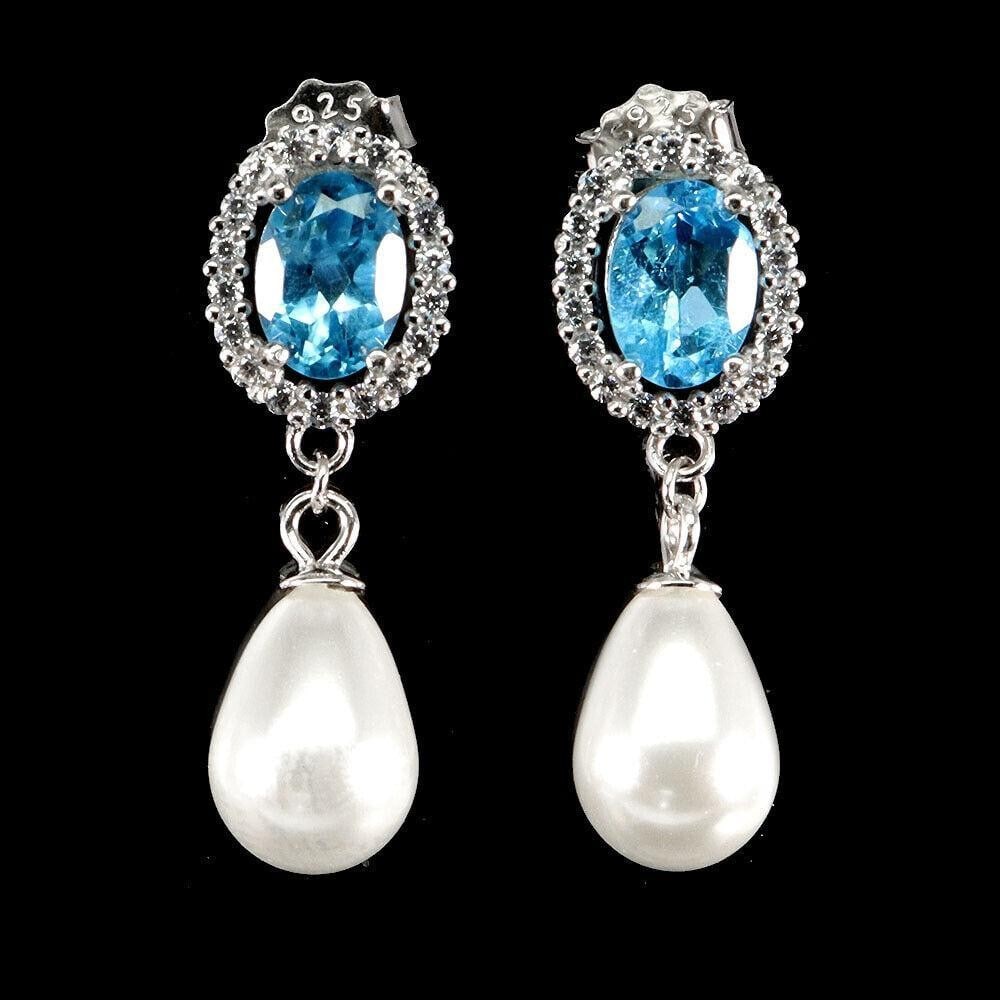 Swiss Blue Topaz & MOP Dangle Sterling Silver Earrings: Swiss Blue Topaz & MOP Dangle Sterling Silver Earrings Illuminate your look with these Swiss Blue Topaz & MOP Dangle Sterling Silver Earrings. Featuring striking Swiss blue topaz stones paire