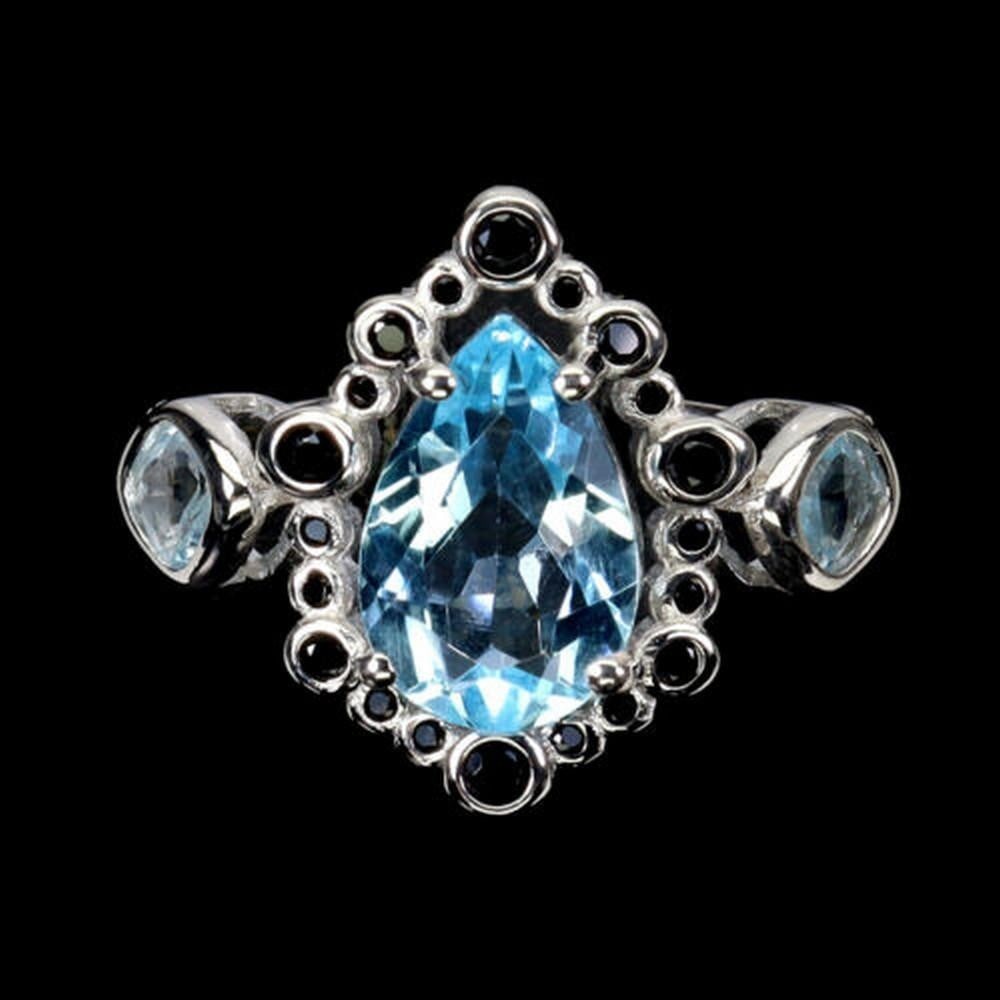 Sterling Silver & Pear Cut Topaz Ring: Sterling Silver & Pear Cut Topaz Ring This Sterling Silver & Pear Cut Topaz Ring features a stunning pear-shaped topaz gemstone set in a delicate sterling silver band. The sparkling blue