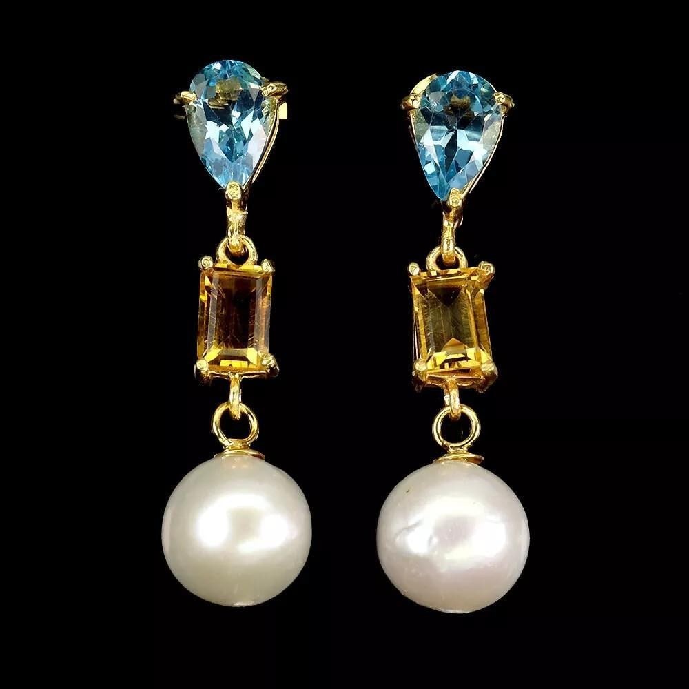 925 Sterling Silver Earrings with Pear Blue Topaz and Pearl: 925 Sterling Silver Earrings with Pear Blue Topaz and Pearl Add a touch of elegance to any outfit with these 925 sterling silver earrings featuring pear-cut blue topaz and luminous pearls. The striki