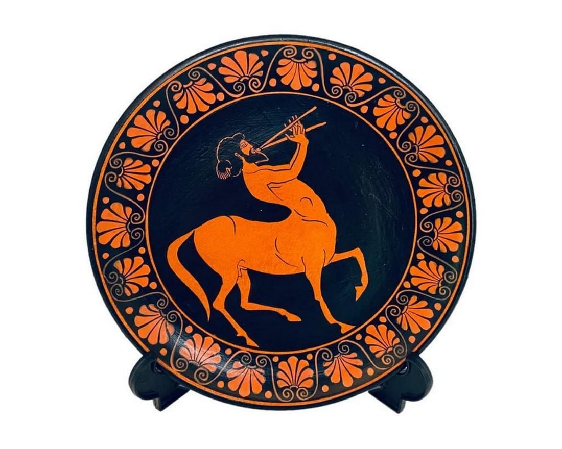 Greek Red-Figure Ceramic Plate Centaur Playing Aulos Replica: Greek Red-Figure Ceramic Plate Centaur Playing Aulos Replica Inspired by ancient Greek mythology, this decorative ceramic plate is red-figure painted, depicting a centaur playing an aulos, the traditi