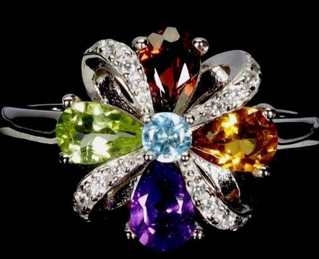 925 Sterling Silver Multi-Gemstone Ring: 925 Sterling Silver Multi-Gemstone Ring This charming 925 sterling silver ring showcases a harmonious blend of genuine gemstones in a timeless design. Featuring four pear-cut gemstones, the ring is