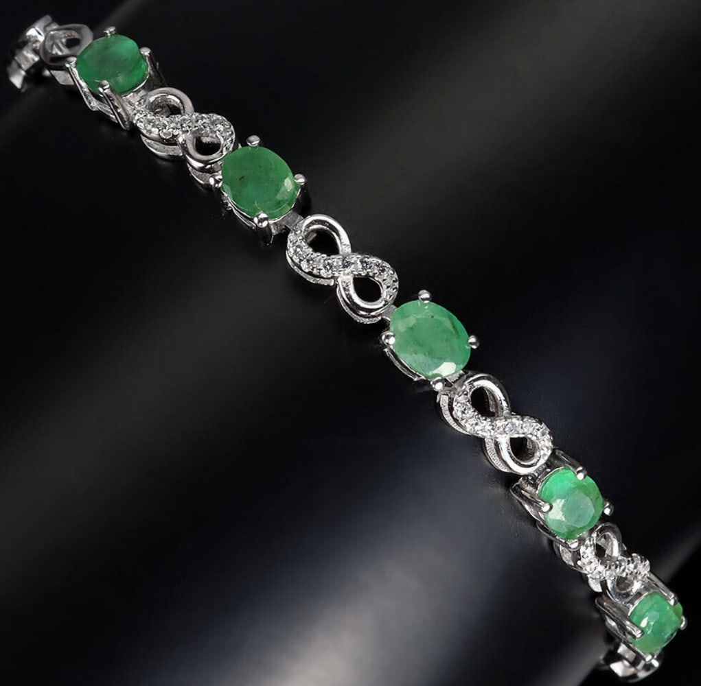 Oval Emerald Stone Infinity 925 Sterling Silver Bracelet - 6": Oval Cut Emerald Stone Infinity 925 Sterling Silver Bracelet - 6.5" At the heart of the bracelet are the oval-cut emerald stones, renowned for their rich green hue and exceptional clarity. Each s