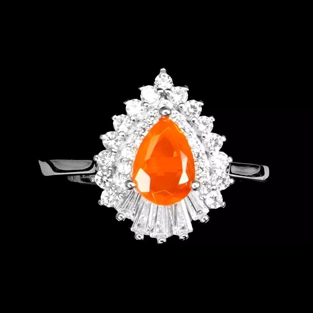 Heated Pear Orange Opal Ring in 925 Sterling Silver – Size 7: Heated Pear Orange Opal Ring in 925 Sterling Silver – Size 7 This exquisite ring features a heated pear-shaped orange opal, set in 925 sterling silver. The vibrant orange opal, with its fiery hues