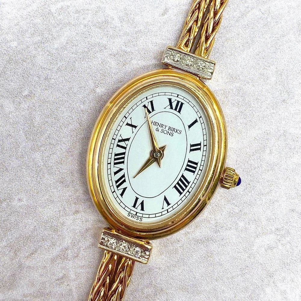 Henry Birks and Son's Sapphire and Crystal 14kt Gold Watch: Henry Birks and Son's Sapphire and Crystal 14kt Gold Watch The Henry Burks and Son's Sapphire Crystal 14kt Gold Ladies Diamond and Double Rope Band Time Piece is an absolutely stunning yet su