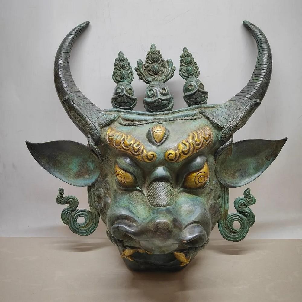 Antique Chinese Bronze Bull Head Statue: Antique Chinese Bronze Bull Head Statue This rare hand-crafted statue showcases traditional Chinese artistry, featuring a finely sculpted bull head made from bronze. The detailed craftsmanship highli