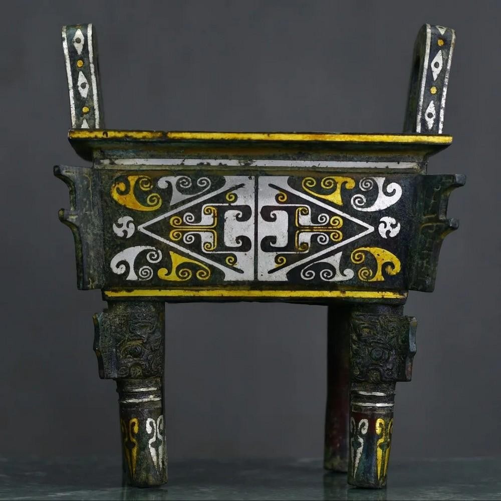 Antique Chinese Bronze Inlaid Gold and Silver Square Tripod Statue: Antique Chinese Bronze Inlaid Gold and Silver Square Tripod Statue This rare hand-crafted tripod statue showcases the artistry of traditional Chinese metalwork, featuring intricate bronze inlay with