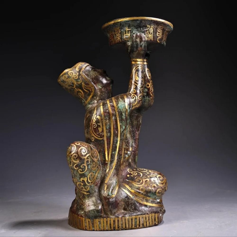 Antique Bronze Inlaid Gold Kneeling Oil Lamp Statue: Antique Bronze Inlaid Gold Kneeling Oil Lamp Statue This rare and masterfully handcrafted Chinese antique kneeling oil lamp statue embodies centuries of artistry and tradition. Made from pure bronze