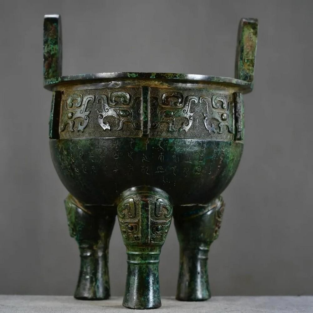 Antique Chinese Bronze Tripod Ornament: Antique Chinese Bronze Tripod Ornament This rare handcrafted bronze tripod features a timeless design steeped in Chinese tradition. With its three-legged structure symbolizing stability and harmony,