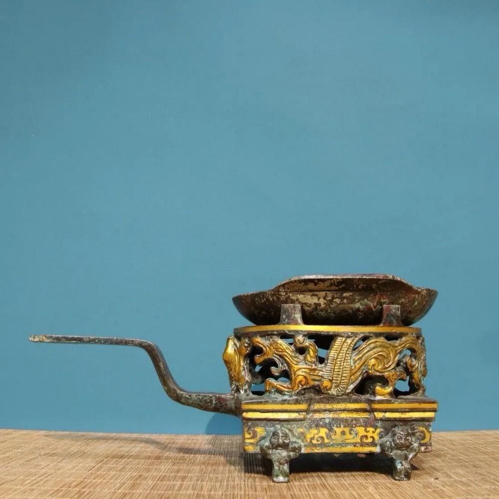 Antique Chinese Gilt Bronze Wine Warmer Ornament: Antique Chinese Gilt Bronze Wine Warmer Ornament This antique gilt bronze wine warmer ornament exudes elegance and functionality, reflecting the sophistication of ancient Chinese traditions. Adorned