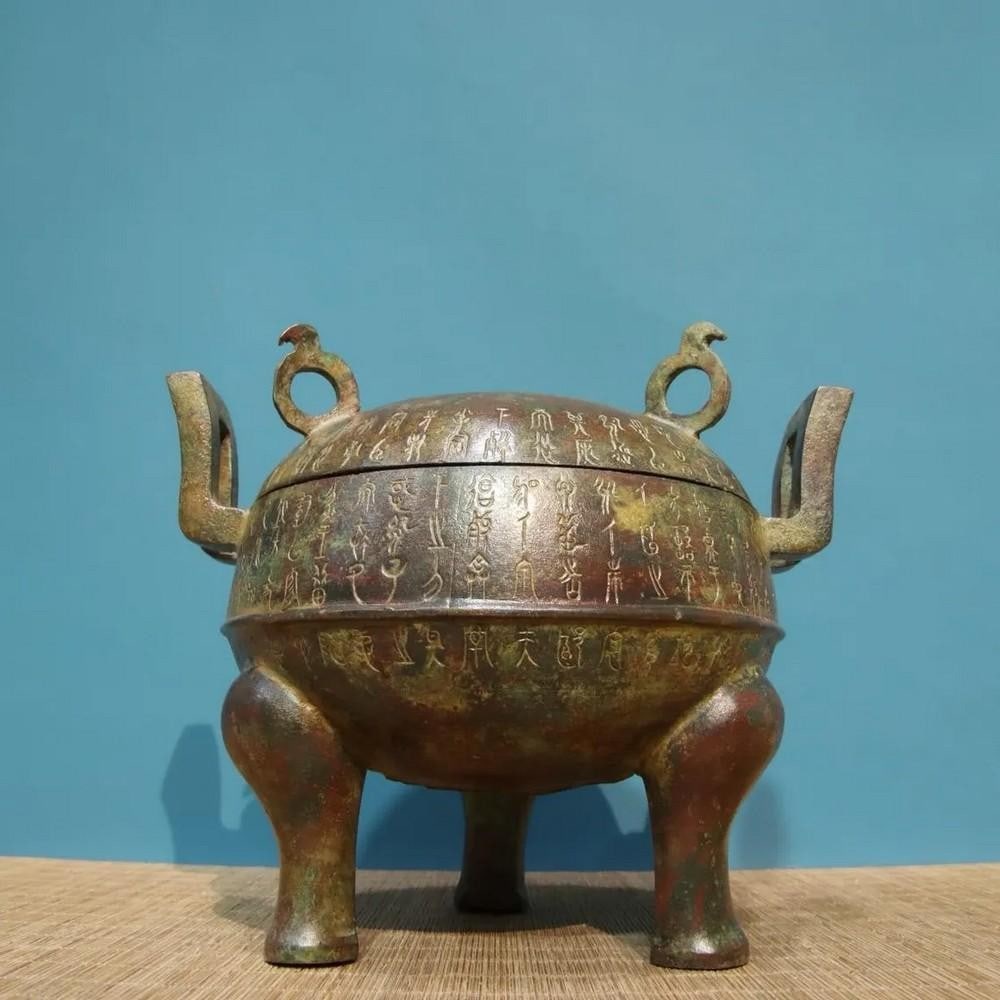 Antique Chinese Bronze Inscribed Yuan Gai Ding Statue Ornament: Antique Chinese Bronze Inscribed Yuan Gai Ding Statue Ornament This rare handcrafted bronze statue features the intricate design of a Yuan Gai Ding, a traditional Chinese ritual vessel, adorned with