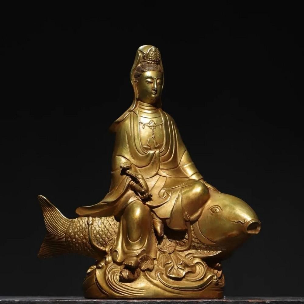 Pure Copper & Gilt Buddha Statue of Guanyin Riding a Fish: Pure Copper & Gilt Buddha Statue of Guanyin Riding a Fish This striking Pure Copper & Gilt Buddha Statue depicts Guanyin riding a fish, symbolizing tranquility and the ability to navigate thr