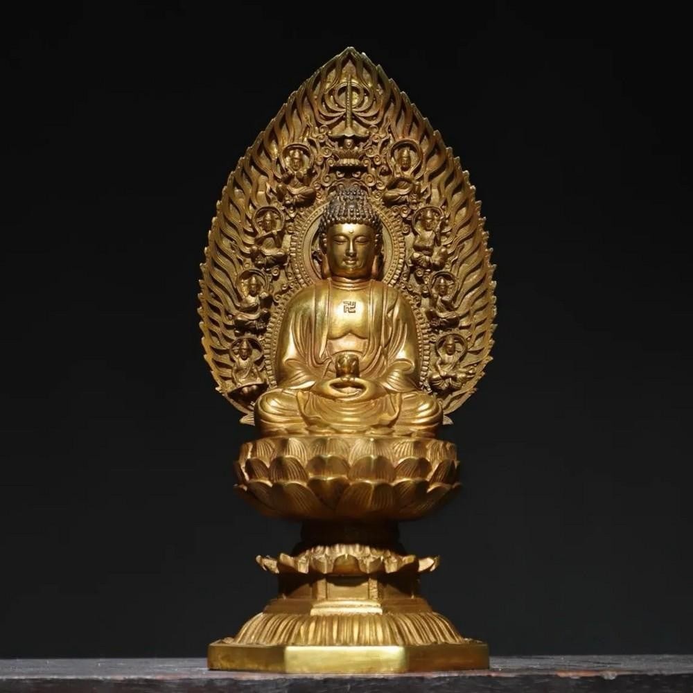 Pure Copper & Gilt Lamp Buddha Statue: Pure Copper & Gilt Lamp Buddha Statue This elegant Pure Copper & Gilt Lamp Buddha Statue showcases a Buddha seated gracefully with a lamp in hand, symbolizing the illumination of wisdom. Craft