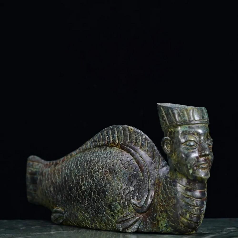 Antique Chinese Humanoid Fish Bronze Statue: Antique Chinese Humanoid Fish Bronze Statue This antique Chinese bronze statue depicts a humanoid fish, a mythical figure symbolizing transformation and harmony between realms. The intricate detaili