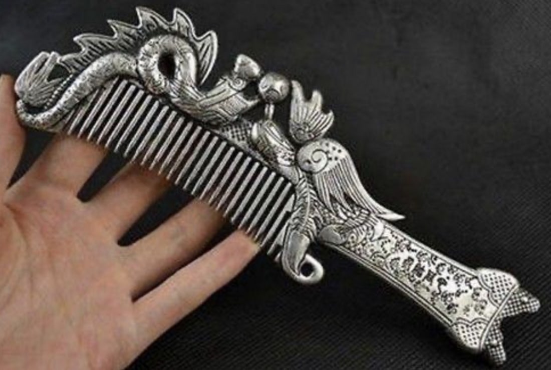 Miao Silver Phoenix and Dragon Comb: Miao Silver Phoenix and Dragon Comb Inspired by ancient legends, the comb features intricately carved phoenix and dragon motifs, symbolizing grace, power, and prosperity. Dimensions- 7" L x