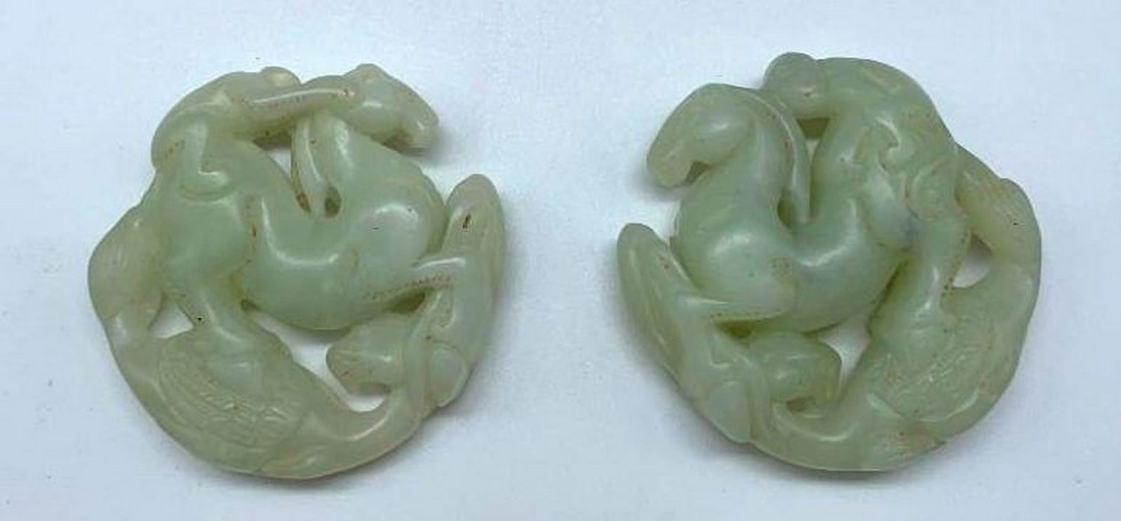 2 White Jade Toggles Featuring a Phoenix And a Monkey Riding a Horse: 2 White Jade Toggles Featuring a Phoenix And a Monkey Riding a Horse. Pair of exquisite white jade toggles showcasing a playful monkey riding a horse, symbolizing harmony and prosperity. The phoenix