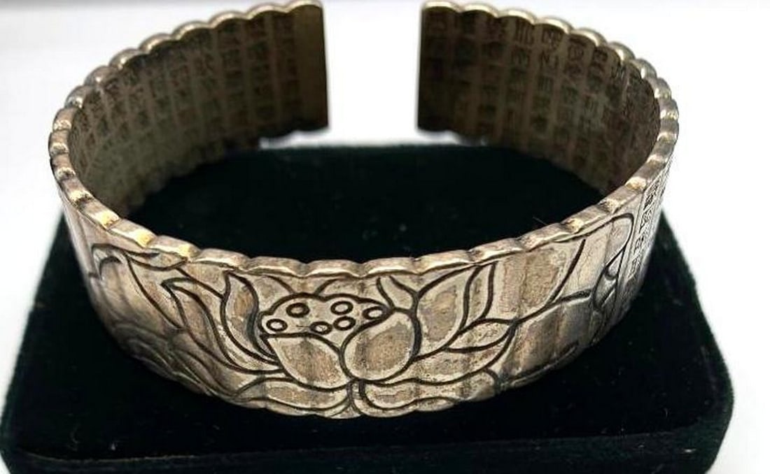 Tibetan Silver Lotus Bangle Bracelet: Tibetan Silver Lotus Bangle Bracelet This stunning piece inspired by spiritual symbolism. Featuring intricate lotus flower engravings, this bracelet embodies purity and enlightenment. Made from durab