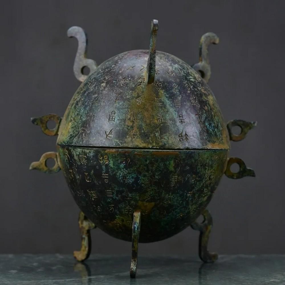 Antique Chinese Bronze Inscribed Watermelon Tripod Statue Ornament: Antique Chinese Bronze Inscribed Watermelon Tripod Statue Ornament This rare handcrafted bronze statue features a unique watermelon-inspired design with tripod legs and intricate inscriptions. Symboli