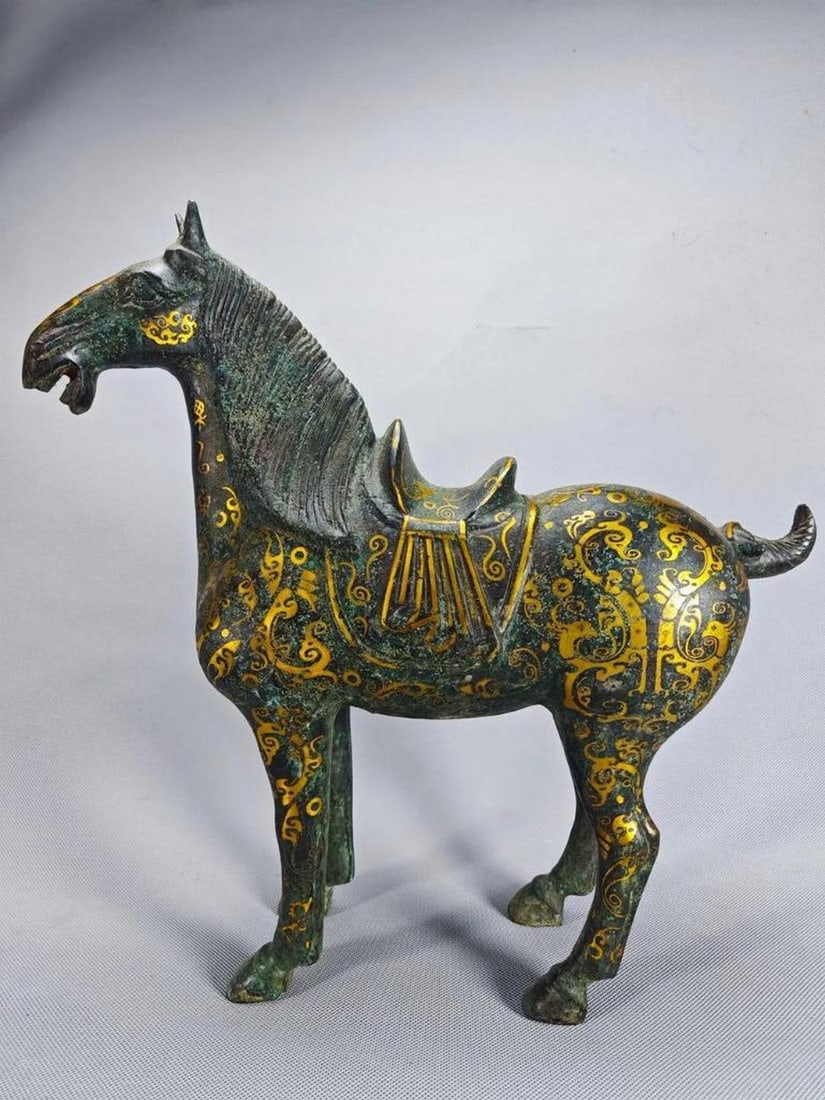 Antique Chinese Gilt War Horse Bronze Statue: Antique Chinese Gilt War Horse Bronze Statue This antique bronze statue of a gilt war horse embodies strength and nobility, reflecting the valor of ancient Chinese warriors. Adorned with finely