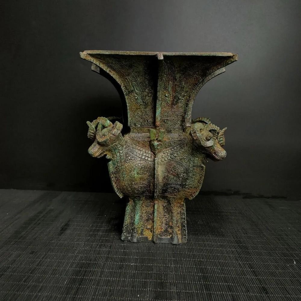 Antique Chinese Four-Ram Square Bronze Ornament: Antique Chinese Four-Ram Square Bronze Ornament This antique Chinese four-ram square bronze ornament features four intricately sculpted rams, symbolizing prosperity, strength, and protection. The