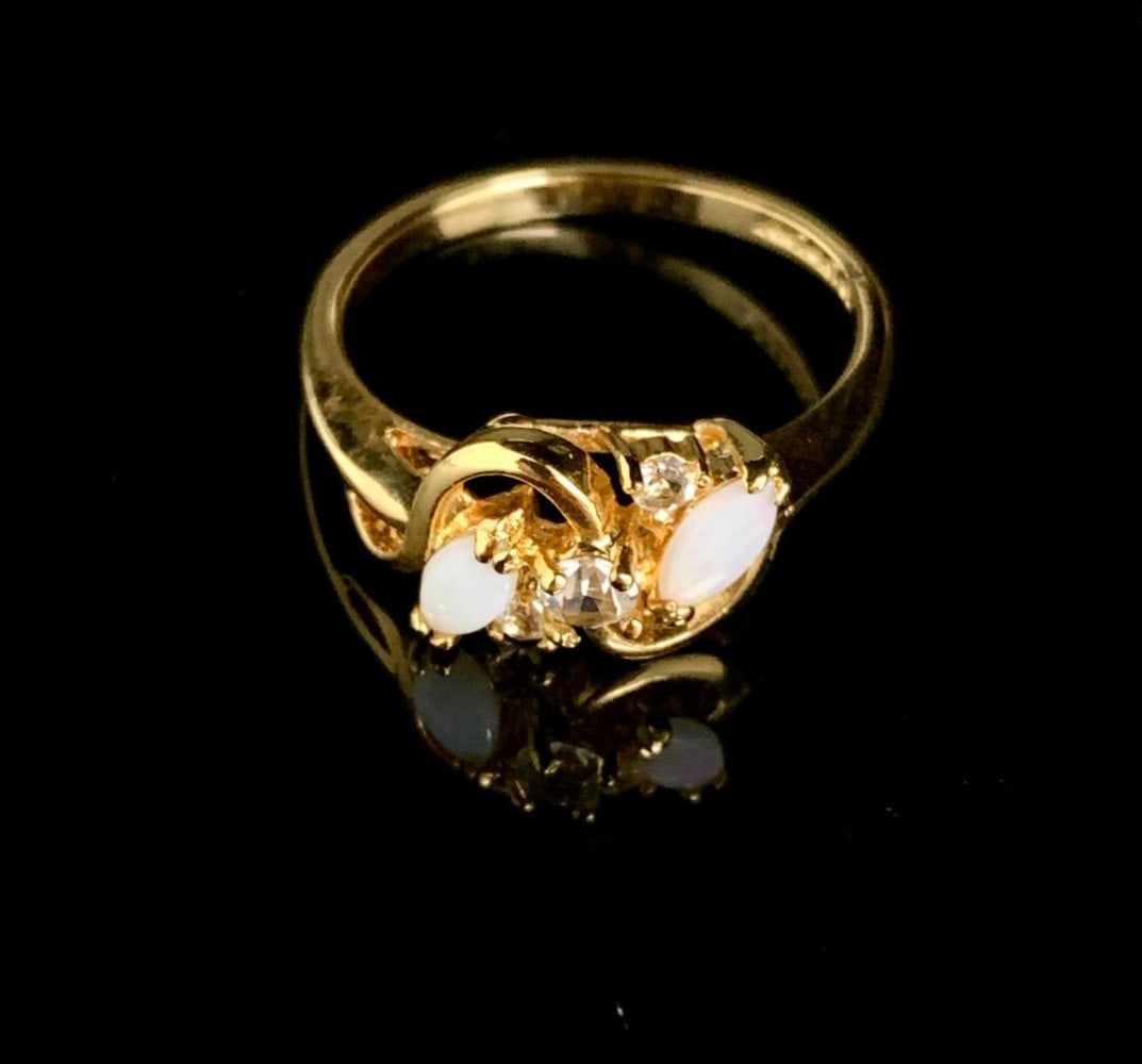 Size 10 .18ct Marquise Cut Opals in 18K Gold Plated Ring: Size 10 .18ct Marquise Cut Opals in 18K Gold Plated Ring. Both stones are at a total weight of .09ct. Please view photos for furhter details.