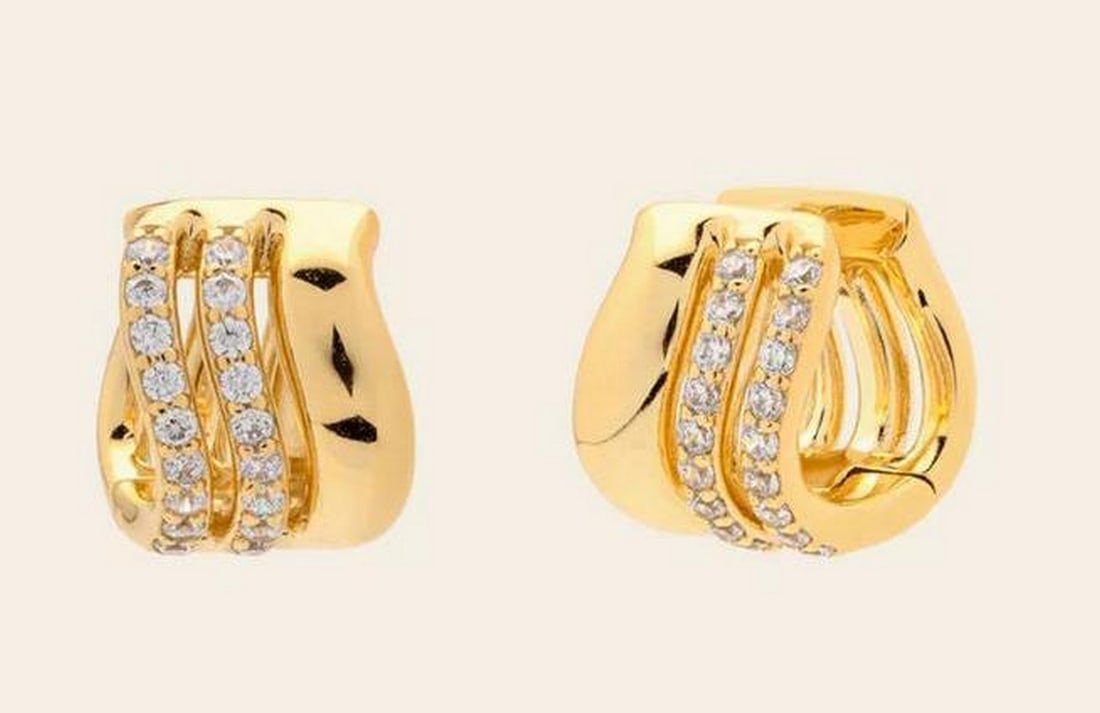 Luminous Trio Huggies: Luminous Trio Huggies Your ear stack’s overachiever, these huggies bring polished shine with pavé CZ detailing that catches the light beautifully. Crafted in 14k gold vermeil, the Luminous Trio
