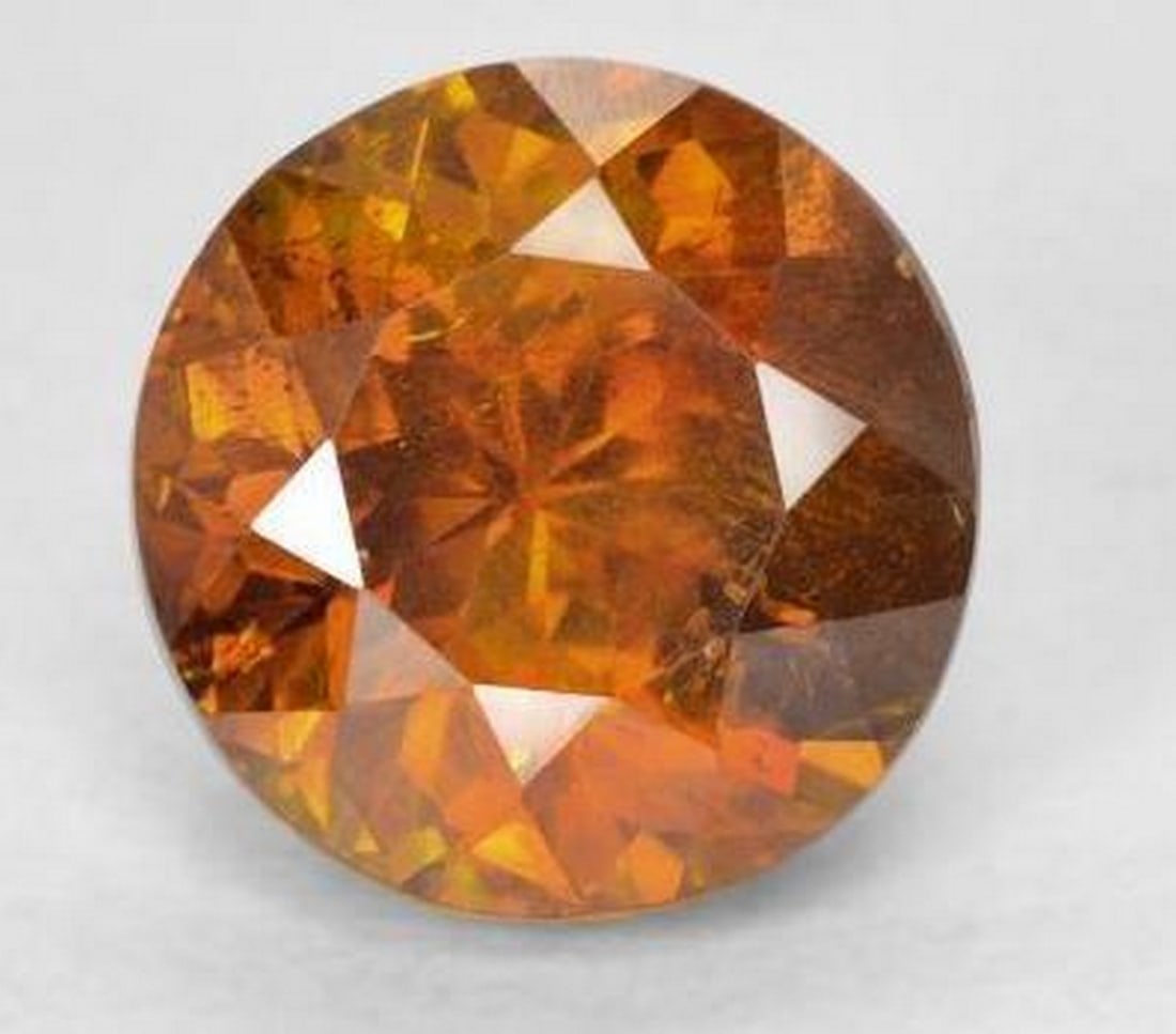 2.24 ct Round Facet Sun-Kissed Orange Sphalerite Gemstone: 2.24 ct Round Facet Sun-Kissed Orange Sphalerite Gemstone Indulge in the allure of our Round Facet Sun-Kissed Orange Sphalerite Gemstone, a 2.24-carat marvel that radiates the warmth of a sunlit