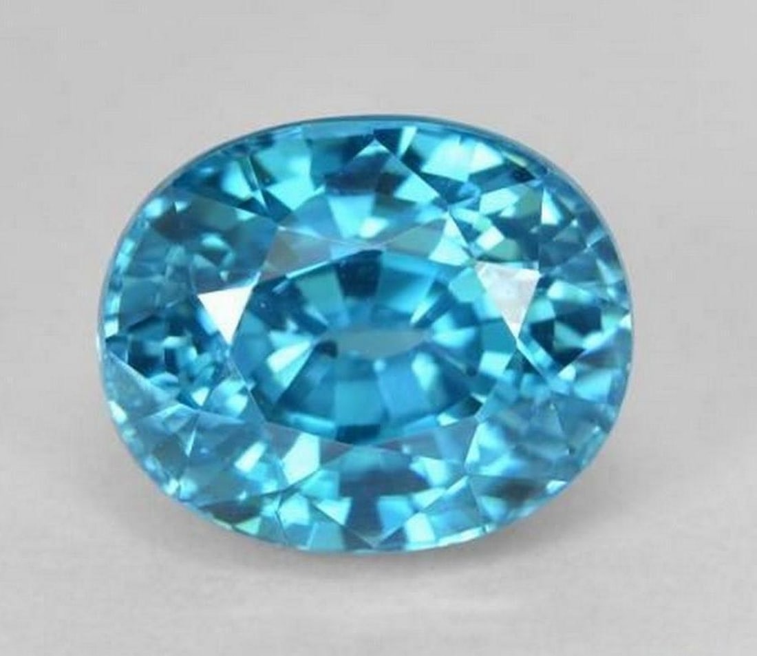 5.88 ct Natural Medium Blue Zircon, Oval Facet, VVS, Cambodia: 5.88 ct Natural Medium Blue Zircon, Oval Facet, VVS, Cambodia Natural zircon gemstone weighing 5.88 carats, cut in an oval facet shape with medium blue color. The gem measures 9.54 x 7.86 x 7.07 mm