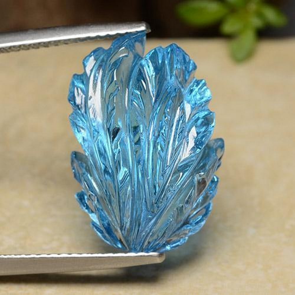 17.01ct Carved Leaf Topaz: 17.01ct Carved Leaf Topaz This unique, hand carved blue topaz leaf is stunning and would make for a beautiful daily wear jewelry. This is traditional August Birthstone. Dimensions 18.6 x